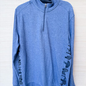 the front of this quarter zip long sleeve, light weight sweatshirt in heathered blue. Shows black mushrooms printed down the front seams at each side.