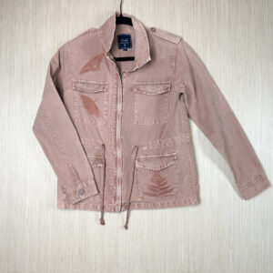 Pale pink canvas jacket printed with low-contrast copper-colored fern growing from the seam of the lower left pocket, with butterflies in the same color on and above the upper right pocket.