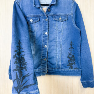 Hand holding sleeve printed with fireweed stamp in black ink.