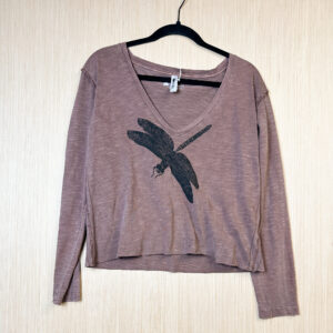 Front of pink v-neck long sleeve shirt with dragonfly print on chest.