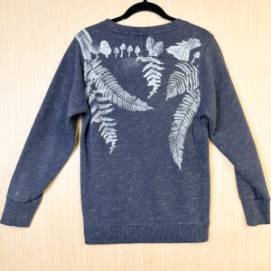 Back of blue sweatshirt with fern and fungi printed in white ink.