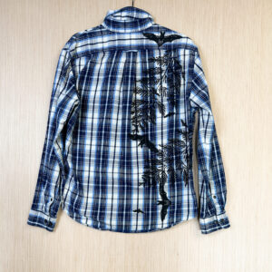 Back of shirt with bats printed flying around cedar branches growing out of right side seam.