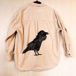 Back of peach color shirt with black raven print.