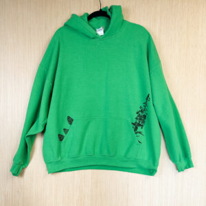 Front of bright green hoodie with three morels printed in black ink growing out of right side of pocket, with fireweed printed growing out of right side.
