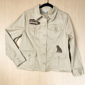 Front of tan jacket with oyster mushroom print above right breast pocket and frog print over lower left pocket, both in brown ink.