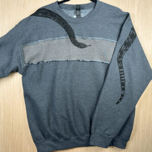 Grey sweatshirt with lighter grey rectangular panel across chest with snake head across front and tail printed on back of left sleeve.