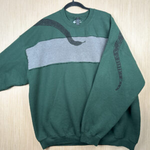 Front of green sweatshirt with grey rectangular panel across front, with black snake head printed coming down from right shoulder, folded over left sleeve showing where tail is printed on back.