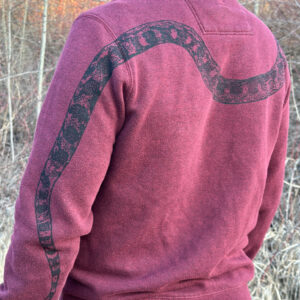 Back of man wearing burgundy sweatshirt with black snake print down left arm and around his back.