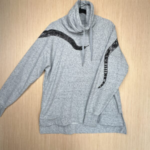 Grey mock neck sweatshirt with snake head across front and tail printed on back of left sleeve.