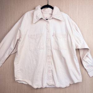 Front of pale pink denim button down shirt.