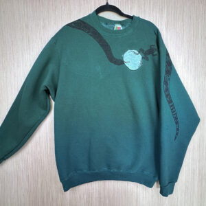 Front of dark green sweatshirt with grey reverse applique octagon sewn at left breast, black snake head printed coming down from right shoulder, folded over left sleeve showing where tail is printed on back.