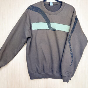 Brown sweatshirt with lighter green rectangular panel across chest with snake head across front and tail printed on back of left sleeve.