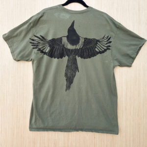 Back of olive green t-shirt with life-size black billed magpie printed with wings spread across back in black ink.