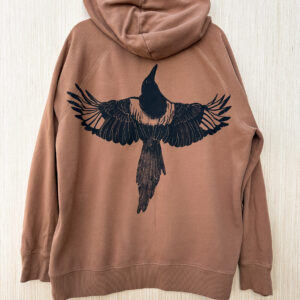 Back of brown hoodie with life-size black-billed magpie with wings spread printed at straight across the back.