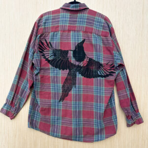 Back of red and blue plaid shirt with life size print of a black-billed magpie across the body.