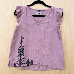 Front of textured cotton sleeveless blouse with ruffle sleeves and a v neck, printed in black ink along lower right hem with fireweed and three morels.