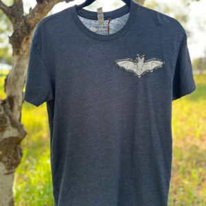 Front of blue t-shirt with a white bat print on a black denim patch sewn on left breast.