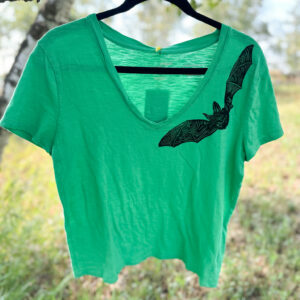 Green v-neck t-shirt with black Allen's long-eared bat printed along left neckline.