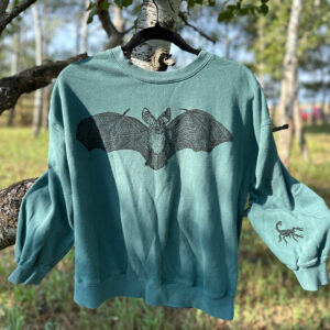 Front of teal green crewneck sweatshirt with pallid bat print across chest and scorpion print on left sleeve.